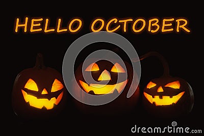 Hello October card. Halloween pumpkin heads glowing Stock Photo