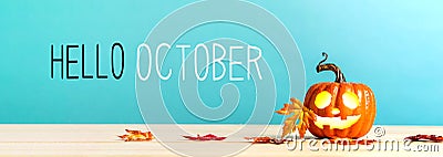 Hello October message with pumpkin on a table Stock Photo