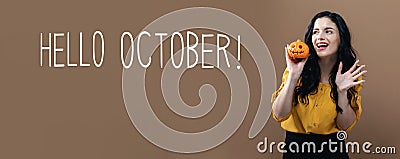 Hello October with woman holding a pumpkin Stock Photo