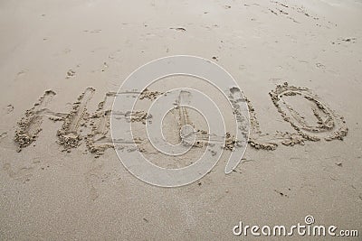 Hello sign word drawing on the sand background Stock Photo