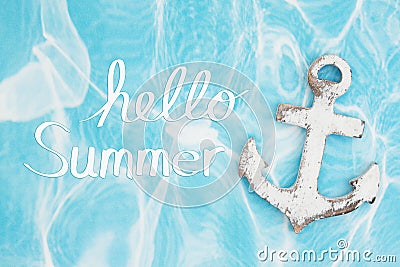 Hello Summer message with weathered anchor on a turquoise paper Stock Photo