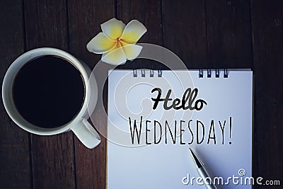 Hello Wednesday. Have a happy, beautiful and productive Wednesday concept. With morning coffee and text greeting on notepad. Stock Photo