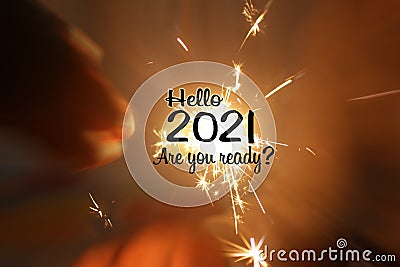 Hello 2021. Are you ready. Happy new year concept with inspirational motivational words on blurry background of small fireworks. Stock Photo