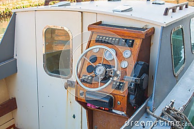 Helm of a boat, vintage wooden navigation panel with steering wheel Stock Photo