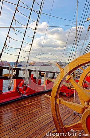 Helm wheel of an old wooden sailboat. Details of the deck of the ship Stock Photo