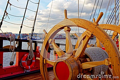 Helm wheel of an old wooden sailboat. Details of the deck of the ship Stock Photo