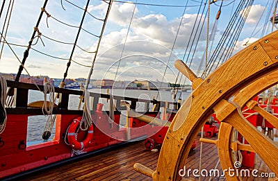 Helm wheel of an old wooden sailboat. Details of the deck of the ship Stock Photo