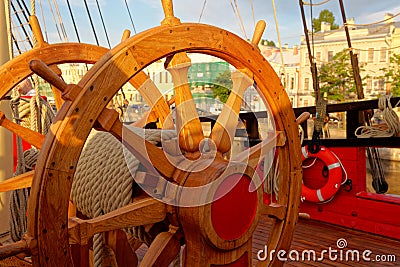 Helm wheel of an old wooden sailboat. Details of the deck of the ship Stock Photo