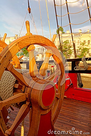 Helm wheel of an old wooden sailboat. Details of the deck of the ship Stock Photo
