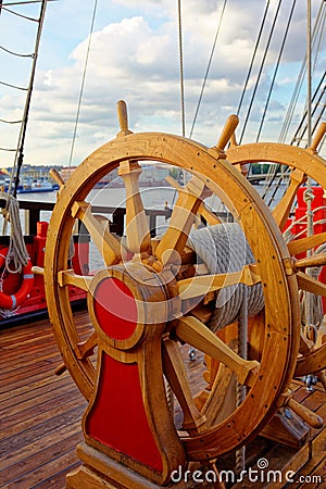 Helm wheel of an old wooden sailboat. Details of the deck of the ship Stock Photo