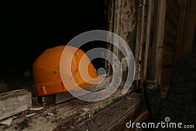 A fireman helmet on a windowsill after the fire Stock Photo