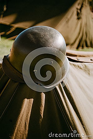Helmet on tent stake Stock Photo