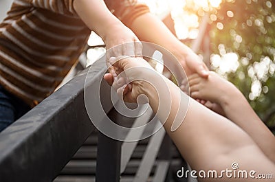 Help concept hand reaching out for help with light flare Stock Photo