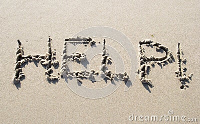 Help handwritten on sand beach Stock Photo