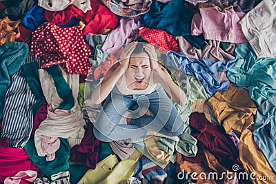 Help. High angle above view photo of stressed yelling lady stay home spring cleaning household sit many clothes stack Stock Photo