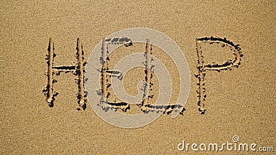 Help - inscription on the sand by the ocean Stock Photo