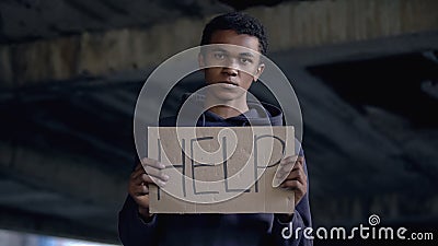 Help sign in black teenager hands, sad violence victim, human rights, bullying Stock Photo