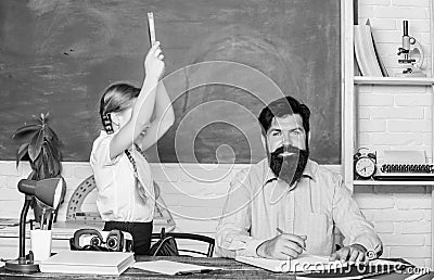 Help study. Discipline and upbringing. Man bearded pedagogue study together with kid. Study is fun. School teacher and Stock Photo