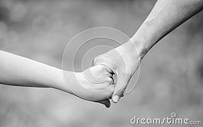 Help and support. father hold his child with hand. hands together. family values and love. family bonding time. Hands Stock Photo