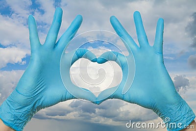 Help, support, healthy lifestyle, healthcare, medicine and ambulance concept. Doctor hands making heart against sky Stock Photo