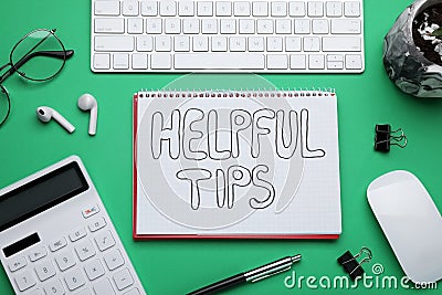 Helpful Tips. Flat lay composition with notebook, calculator and computer keyboard on green background Stock Photo