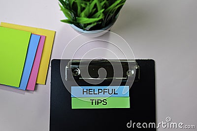 Helpful Tips text on sticky notes with office desk concept Stock Photo