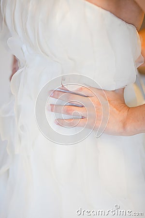 Helping the bride to put her wedding dress on Stock Photo