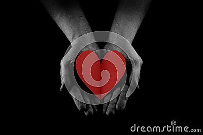 Helping hand concept, Man`s hands palms up holding a Red Heart, giving love, care and support, reaching out Stock Photo