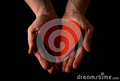 Helping hand concept, Man`s hands palms up holding a Red Heart, giving love, reaching out Stock Photo