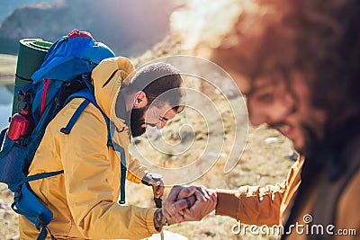 Hiker man getting help on hike happy overcoming obstacle Stock Photo