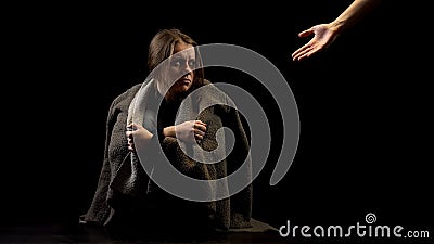 Helping hand offering support to abused woman, victim of domestic violence Stock Photo