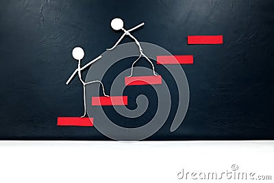 Helping hand, support and teamwork concept. Two human stick figures climbing a red ladder. Stock Photo