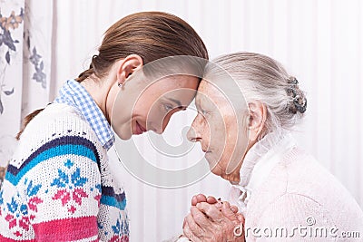 Helping hands, care for the elderly concept Senior and caregiver holding hands at home Stock Photo