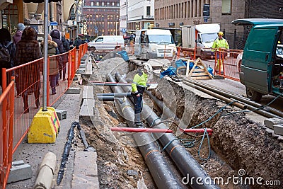 HELSINKI, FINLAND 18 DEC 2018: Human inspector checks how the work is done. Replacement pipes in the city Editorial Stock Photo