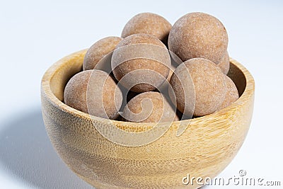 Traditional Finnish cuisine: A bowl of salty licorice coated traditional licorice against a white background Stock Photo