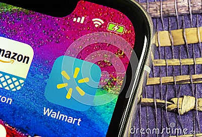 Walmart application icon on Apple iPhone X screen close-up. Walmart app icon. Walmart.com is multinational retailing corporation Editorial Stock Photo