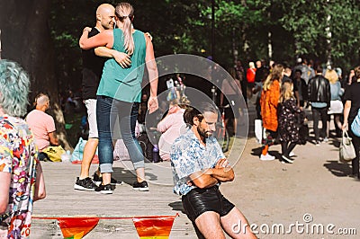 Sad man in black leather shorts on Helsinki Pride festival in Kaivopuisto public park Editorial Stock Photo