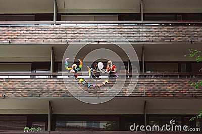 Women on balcony welcome participants on street of Helsinki Pride festival Editorial Stock Photo