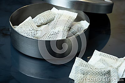 Closeup of a metallic swedish snus can and portion snuff pouches Stock Photo