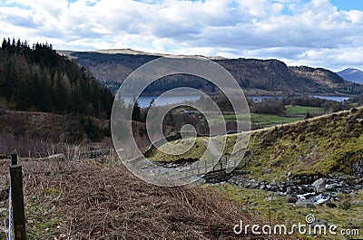 Footbridge over Helvellyn Gill with Thirlmere beyond Stock Photo