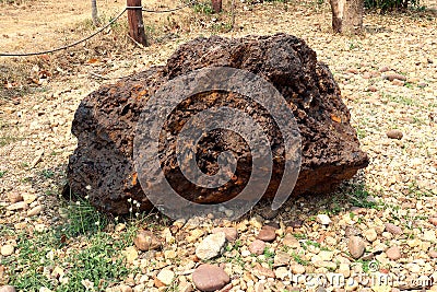 Hematite stone, stone surface with layers of Hematite and layers of Quartz. Iron Ore, on ground field Stock Photo