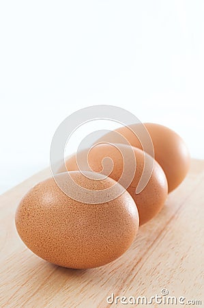 Hen chicken layers uncooked eggs three close up Stock Photo