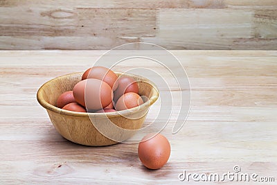 Hen's eggs in wooden bowl Stock Photo