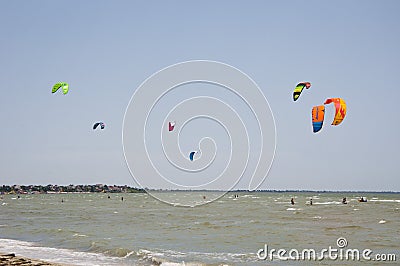 Henichesk, Ukraine - July 12, 2021: Kitesurfing. Practicing kitesurfing at summer beach. Kitesurfer doing tricks. People enjoy Editorial Stock Photo