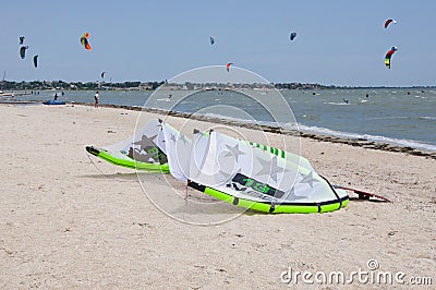 Henichesk, Ukraine - July 12, 2021: Kitesurfing. Practicing kitesurfing at summer beach. Kitesurfer doing tricks. People enjoy Editorial Stock Photo