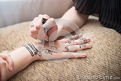 Henna mehendi on hand. Drawing, artwork. Asian Stock Photo