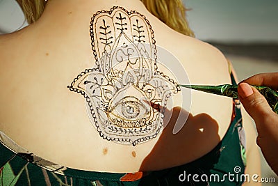 Henna tattoo mehendy painted on back Stock Photo