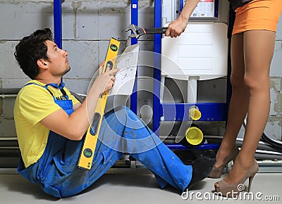 Henpecked husband plumber Stock Photo