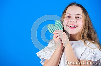 Her sweet smile warms the hearts. Happy child with adorable smile holding small heart. Little girl with happy smile on Stock Photo