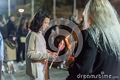 Heraklion, CRETE, GREECE - 28 APRIL 2019: People celebration with lit candles Easter night outside Agios Minas Cathedral Editorial Stock Photo